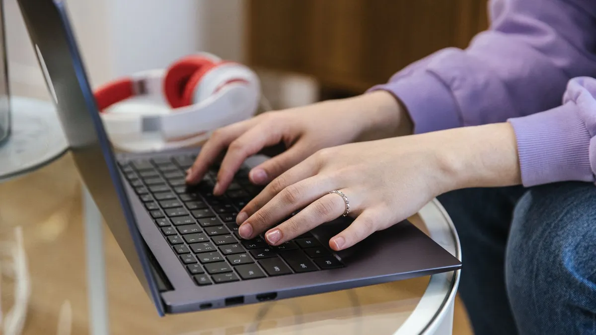 Person completing a same day loan application quickly on a laptop before the afternoon cutoff